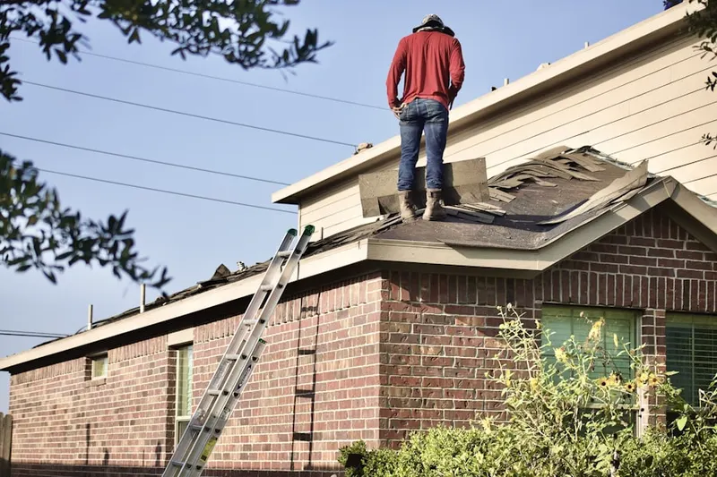 Professional roofer working on a residential roof in Danbury Village